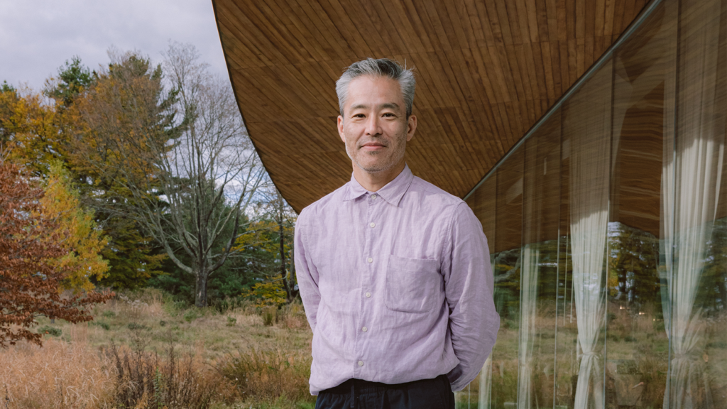 Architect Toshihiro Oki standing in front of the River building at Grace Farms