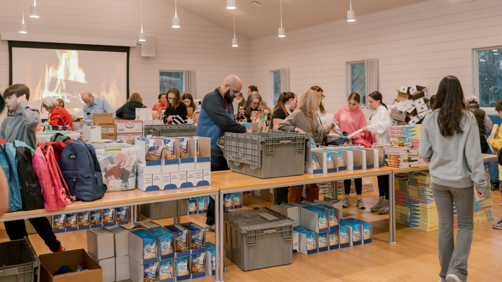 Visitors attend Grace Farms' annual gift giving evening, Gifting for Good, and wrap presents together.